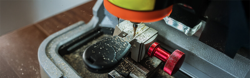 Assorted car keys hanging on a wall